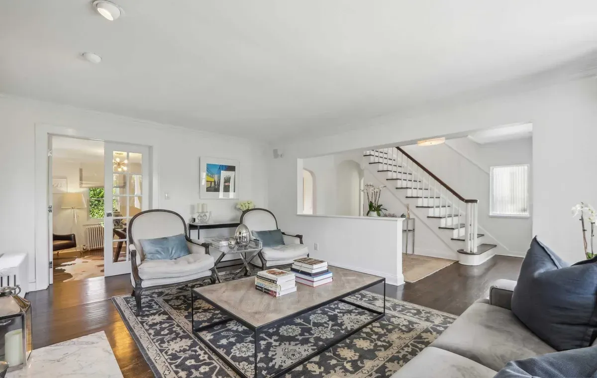 Living room with antique armchairs and patterned rug