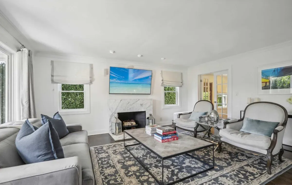 Living room with marble fireplace and layered seating