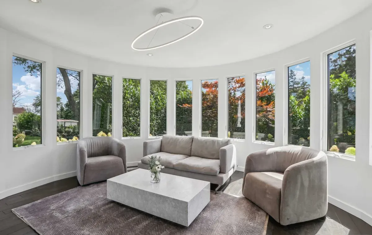 Curved sunroom with floor-to-ceiling windows